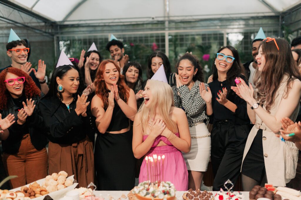 pexels photo 32333373 32333373 A group of friends joyfully celebrating a birthday party indoors with food and laughter.