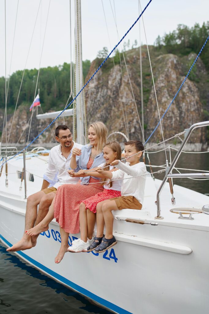 pexels photo 5368730 5368730 Full body of happy parents and children spending time together on sailboat in sea